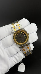Nivada Royal Oak cadran noir gaufré lunette or